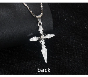 Macro detail of the diamond-textured back on the silver stainless steel cross pendant