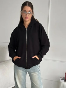 Detail view of the metal zipper and hood design on a black oversized zip-up hoodie