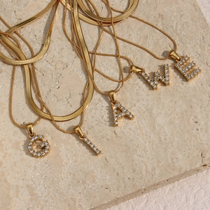 Detail of 18K gold-plated double-layer chains with sparkling zircon letter pendants