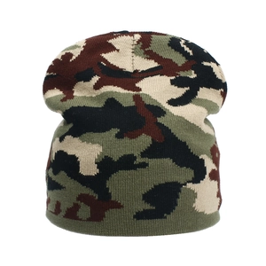 Detail of camouflage knitted beanie with green and brown patterns for winter warmth