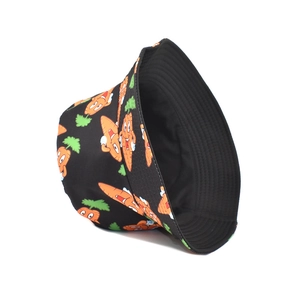 Detail view of the black bucket hat featuring cute cartoon carrot patterns on twill fabric