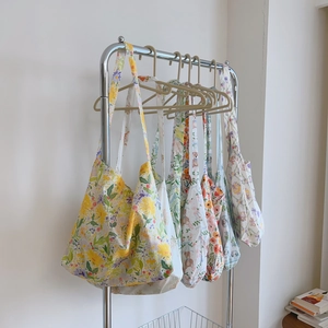 French country style floral cotton tote bags hanging on a rack in a minimalist room