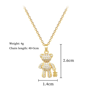 Macro shot of gold bear pendant with crystals and detailed chain dimensions