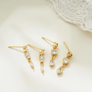 Detailed macro view of 18K gold earrings with sparkling zircon tassels on lace decor