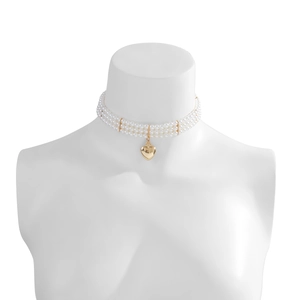 Close-up of triple-layer pearl choker necklace with a polished gold heart pendant