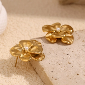 Macro shot of 18K gold plated double petal flower earrings with central white pearls