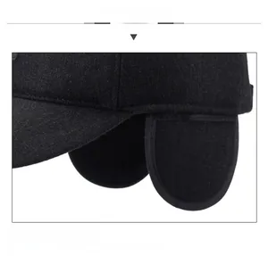 Detailed view of the thick wool fabric and foldable ear flaps on a men's winter cap