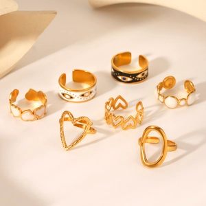 Stack of gold heart-shaped and evil eye stainless steel rings for minimalist women