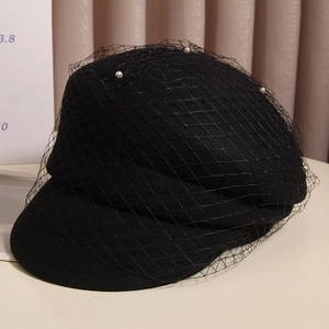 Elegant black wool beret with delicate pearl embellished mesh veil for a vintage look