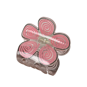 Floral macaron hair claw clip with pink spiral patterns on transparent plastic