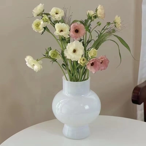 Minimalist white opal glass spherical vase with cream and pink flowers for home decor
