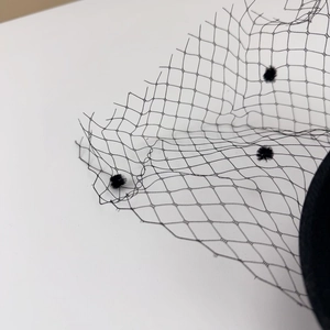 Close-up of black mesh veil with flocked polka dots for vintage fascinator hats