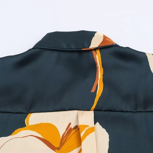 Close-up of floral print satin shirt with detailed collar and back shoulder stitching