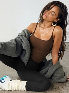 Detailed view of dark brown slim fit camisole paired with a grey fleece hoodie and yoga pants