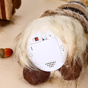Detail view of gnome doll base showing battery compartment and power switch with certification