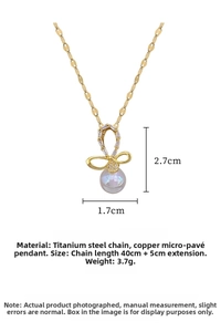 Detailed view of titanium steel bow necklace with sparkling crystals and a lustrous pearl