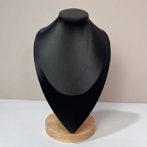 Detail of black matte necklace bust display stand with natural beech wood base