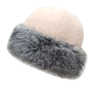 Detail of the dual-tone plush bucket hat with thick faux fur trim and beige velvet crown