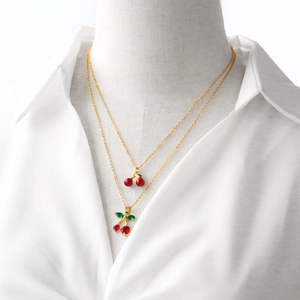 Double-layered gold-plated necklace featuring cherry pendants with red faceted crystals