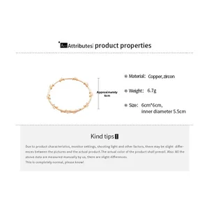 Detail showing 5.5cm inner diameter of gold bangle with shimmering zircon stones