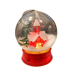 Christmas glow globe with a red house and pine tree in a snow forest landscape