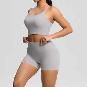 Detailed close-up of light gray yoga set with high-waist shorts and thin-strap sports bra