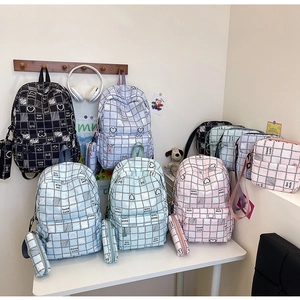 Detailed set of plaid school backpacks with crossbody bags and pencil cases in pastel colors