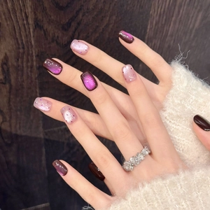 Detailed view of handmade purple cat-eye press-on nails with glitter and glossy finish