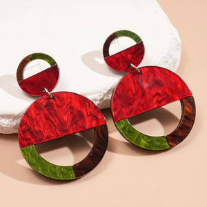 Detail view of large geometric acrylic earrings with colorful marbled resin textures
