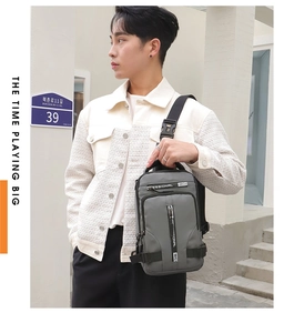Outdoor street view of a grey multifunctional crossbody chest bag with adjustable strap