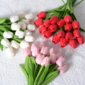 Detailed view of artificial tulip bouquets in white, red and pink colors for home decor