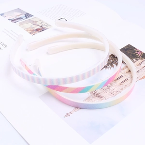 Detail showing colorful rainbow gradient headbands with glitter finish and inner grip teeth