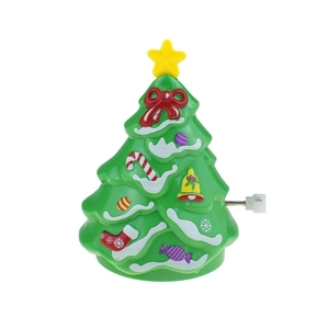 Detail of green wind-up walking Christmas tree toy with festive ornaments and white knob