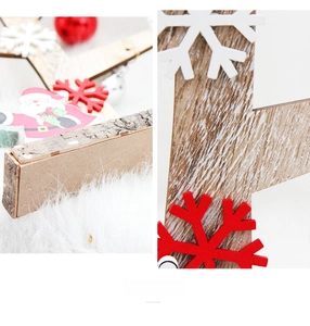 Detail of wooden Christmas ornament with snowflake and bell on a rustic base