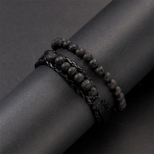 Detail of matte lava stone beads and braided leather strands in a men's bracelet set
