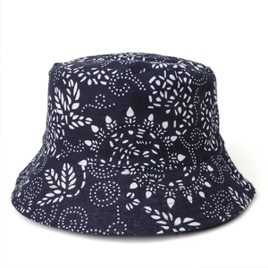 Close-up of navy blue cotton bucket hat with white floral ethnic print and sturdy texture