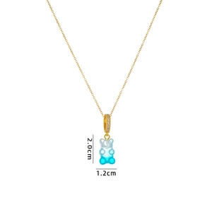 Detail of gradient blue gummy bear pendant on gold chain with dimensions 2.0cm x 1.2cm