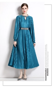 Detailed view of blue pleated dress with beaded collar and rhinestone belt on model