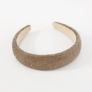 Macro detail of luxury padded headband featuring champagne gold rhinestones and velvet lining