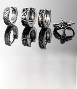 Detailed view of silver titanium steel hoop earrings with cross and zircon accents