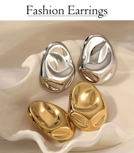 Irregular lava style gold and silver stainless steel earrings on a ceramic tray