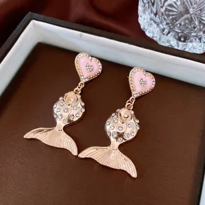 Elegant vintage fish earrings with pink heart and gold-plated cubic zirconia accents