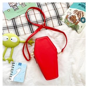 Detailed top view of a red coffin-shaped gothic crossbody bag with gold metal zipper