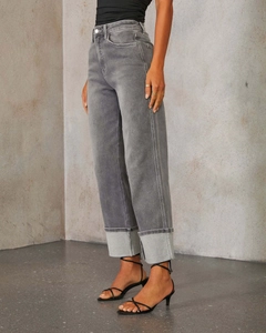 Detail view of high waist grey straight leg jeans with trendy wide folded cuffs and denim texture