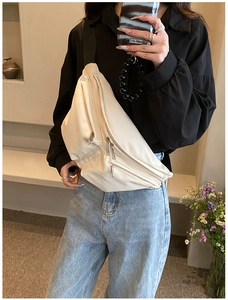 Mirror selfie showing the off-white crossbody chest bag with adjustable wide strap