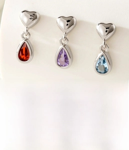 Detailed view of titanium steel heart ear studs with colorful zircon water drop pendants