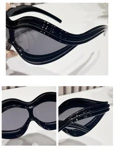 Detailed views of black Y2K sunglasses with unique wavy frames and grey lenses