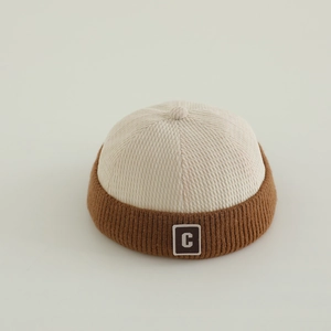 Close-up of color-block kids miki hat featuring cream corduroy and letter C patch