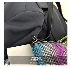 Detailed macro view of purple gradient rhinestones and silver metal hardware on handbag