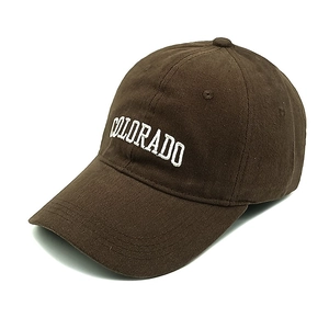 Detail of embroidered COLORADO lettering on brown cotton twill baseball cap